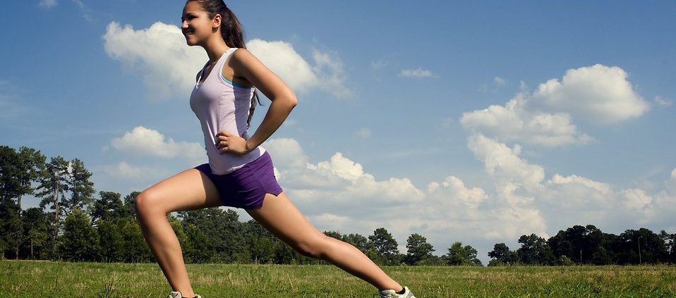 15250-a-young-woman-stretching-outdoors-before-exercising-pv