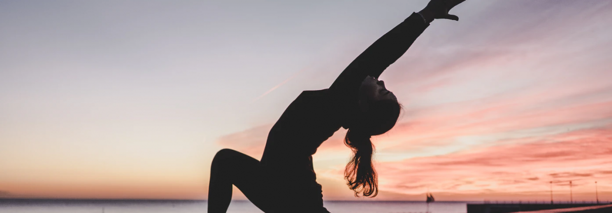 A lady stretching on the pier